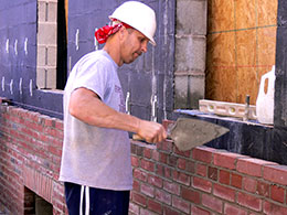 Brick facing a commercial block wall.