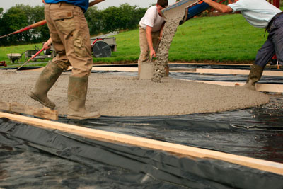 Mason crew pouring concrete.